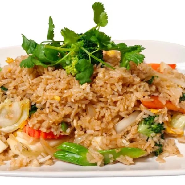 Royal Thai Orchid's Thai fried rice with vegetables and cilantro on a white plate.